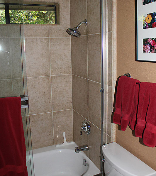 Stone tile shower and bathtub area.