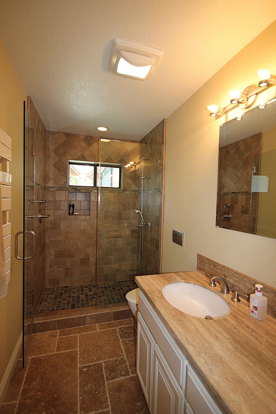 Artistic bathroom stone countertops, flooring and shower stall.