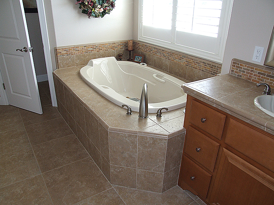 Stone tiling in bathroom, jacuzzi surfaces, countertops, flooring, backsplashes.