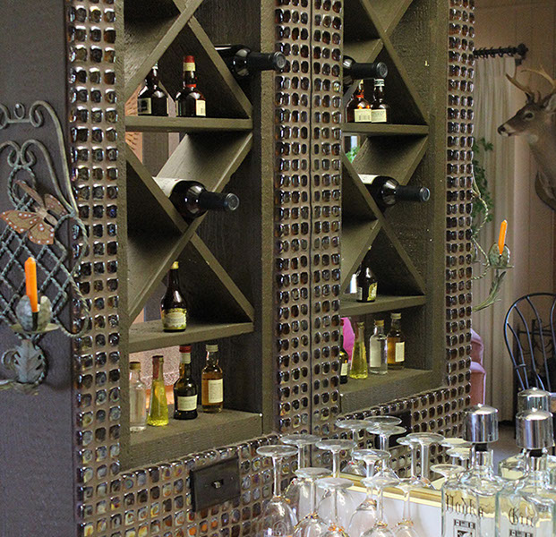 Glass mini tiles on wall of wine storage and display area.