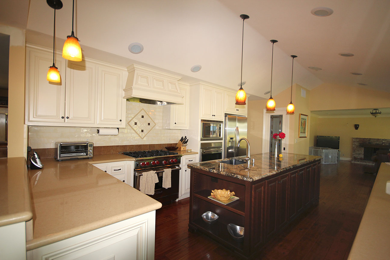 Remodeled kitchen with engineered stone counters and stone tile flooring, design and installation.