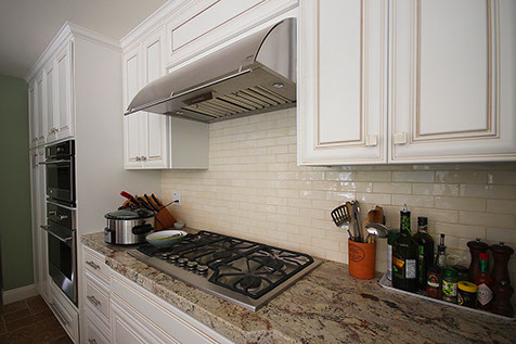Granite countertop and ceramic wall tiles backsplash by Rock Solid Creations in California.