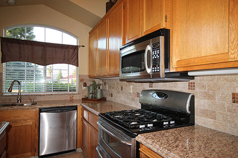 Design and installation of stone countertops and stone tile backsplash for homeowners in Turlock, California by Rock Solid Creations.