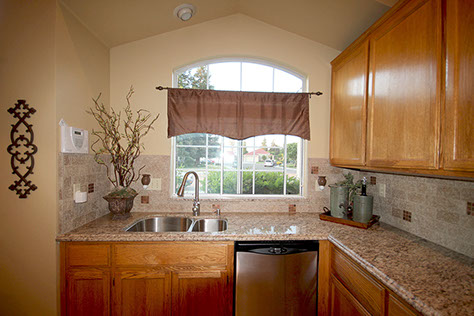 Design and installation of stone countertops and stone tile backsplash for homeowners in Turlock, California by Rock Solid Creations.