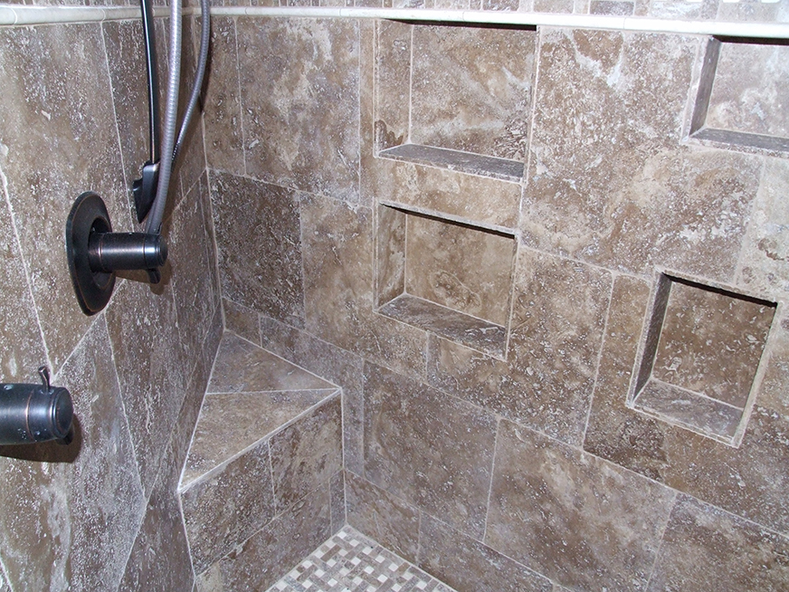 Details and insets in stone tile shower stall.