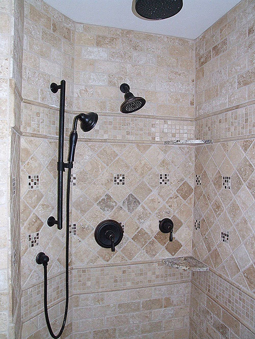 Custom stone tiling installation in shower stall.